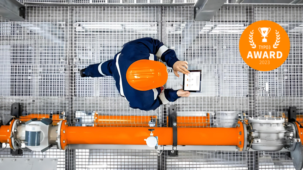 Mann mit orangenem Helm läuft auf einer Plattform 
